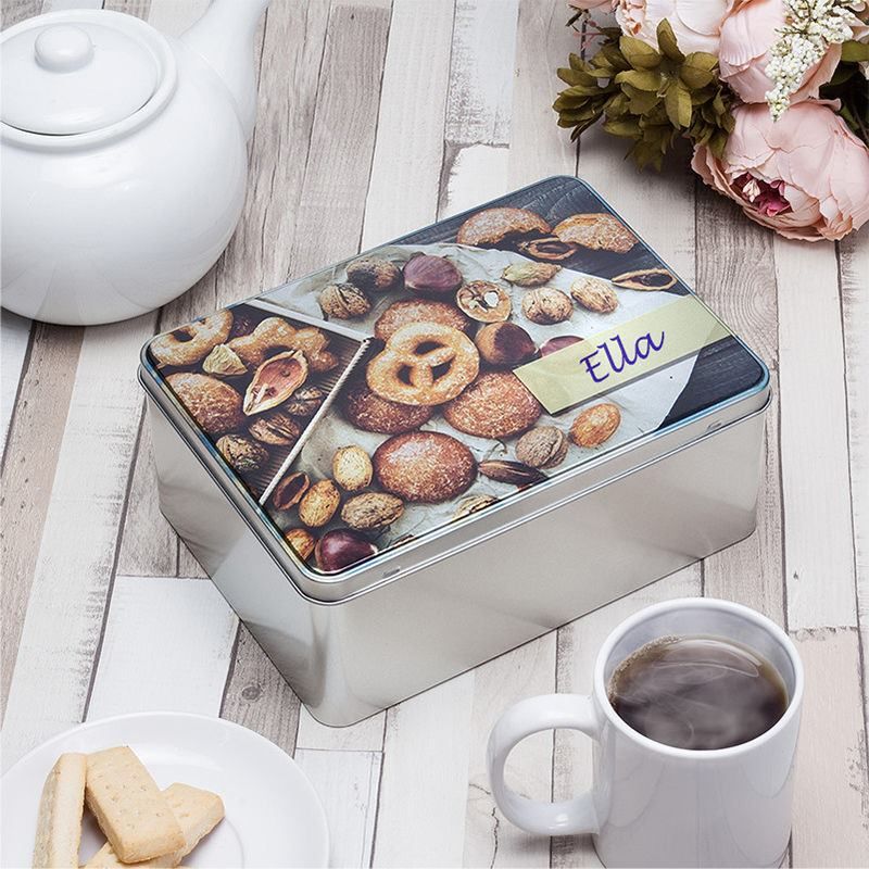 custom biscuit tin on a table setting with tea and biscuits