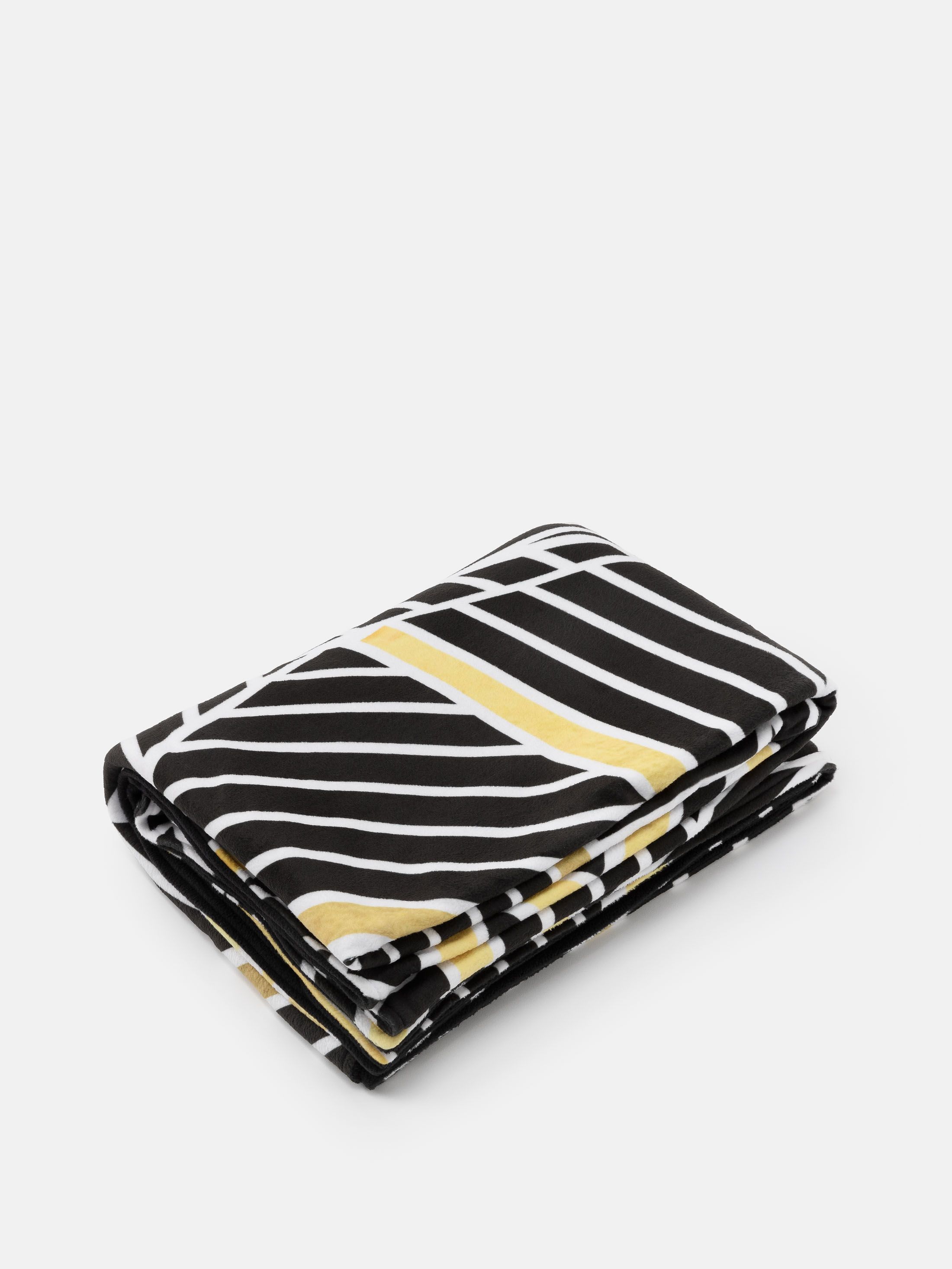 custom blankets folded on bed