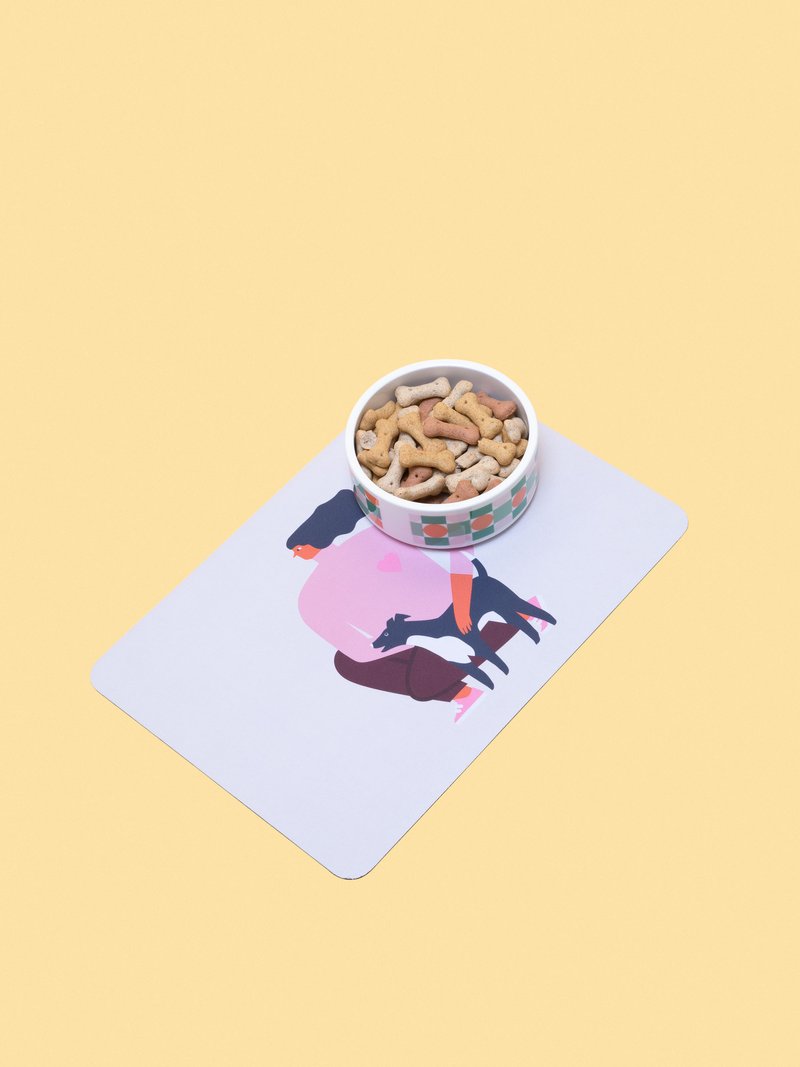 pet bowl mat with pair of shoes on top