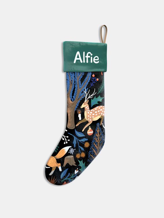 customized Christmas stockings with polar bear design surrounded by fairy lights and festive accessories
