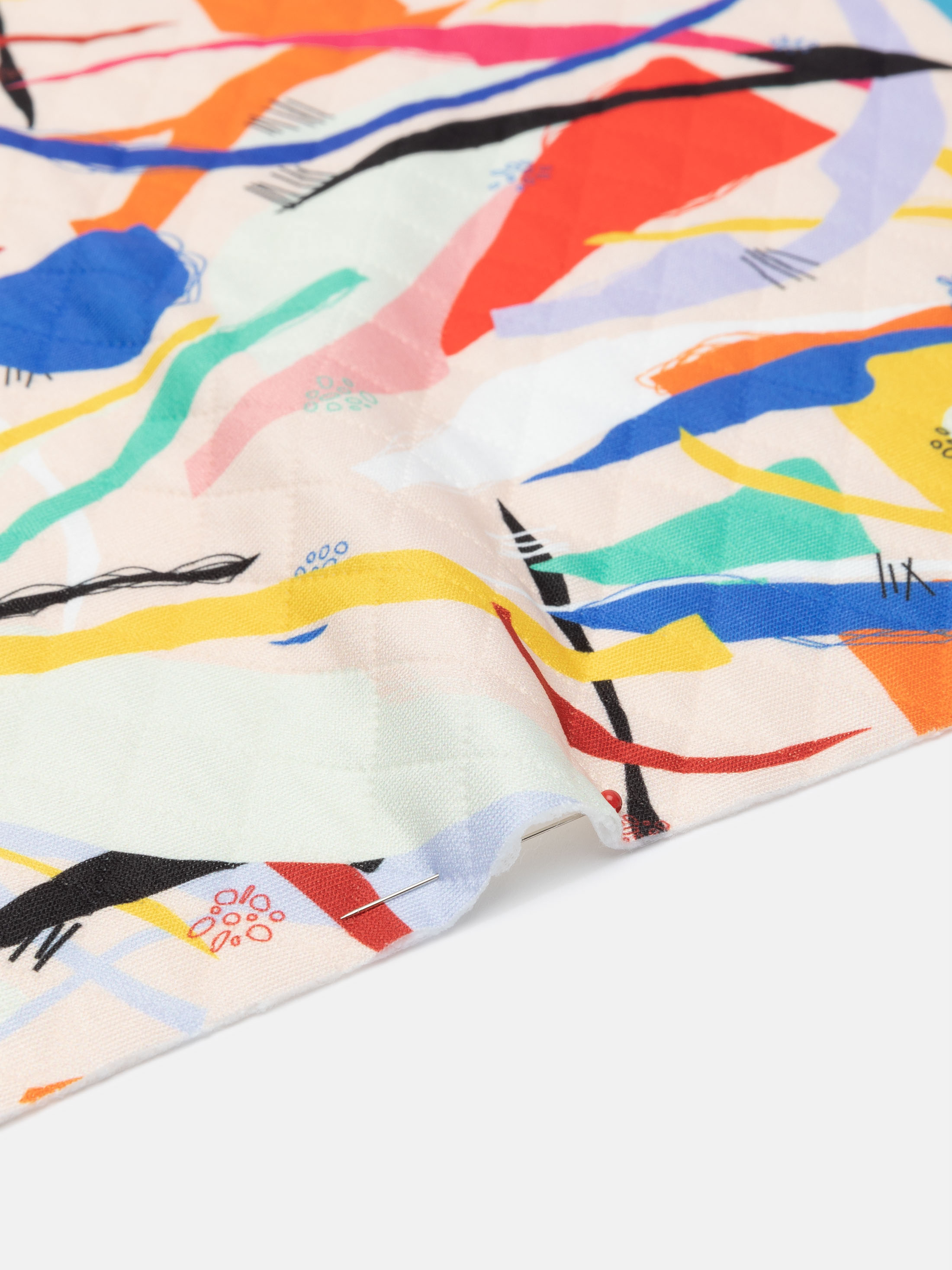 test print and pinned fold of quilted jersey fabric UK