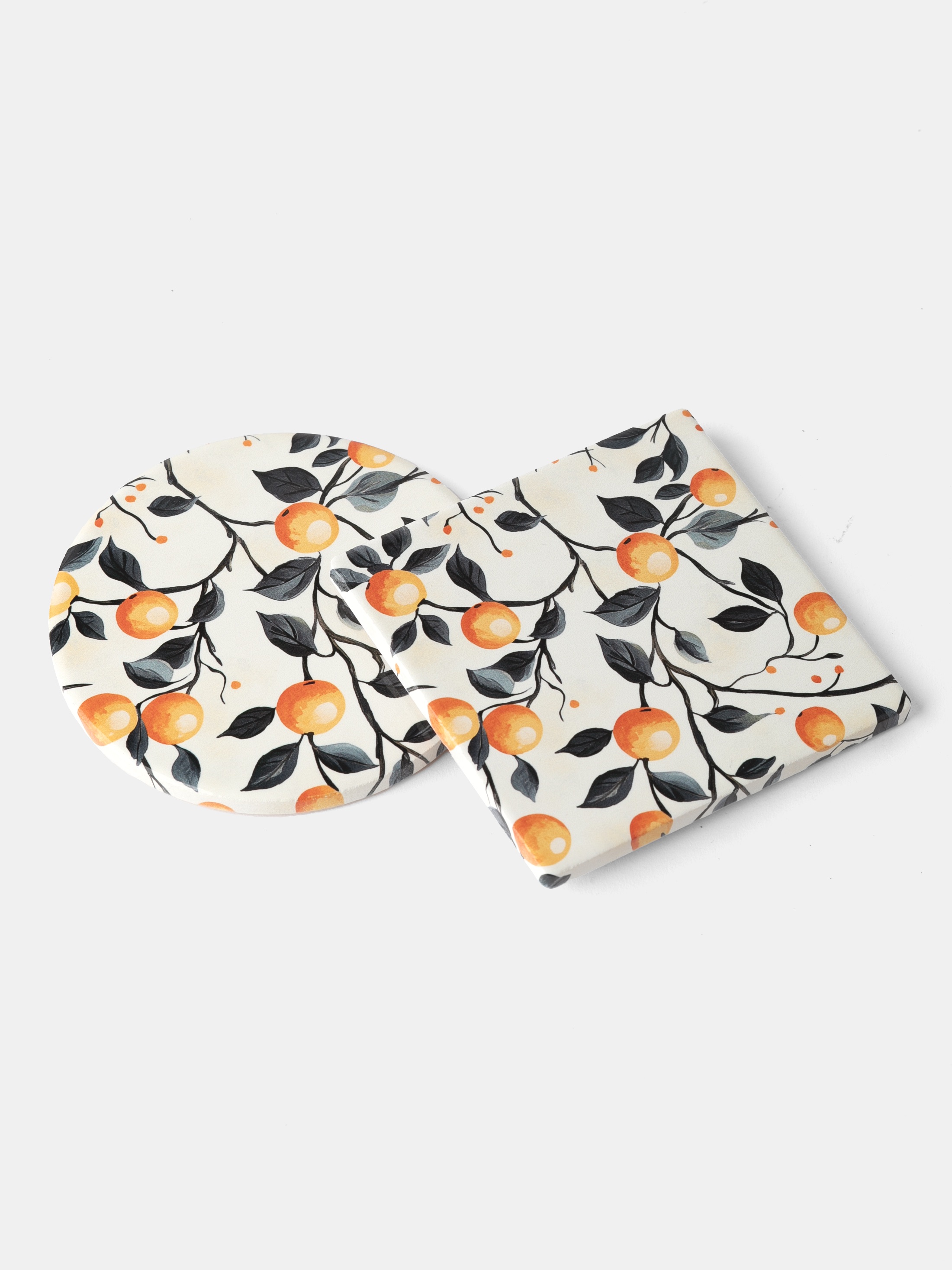flat lay of ceramic coasters with printed orange pattern